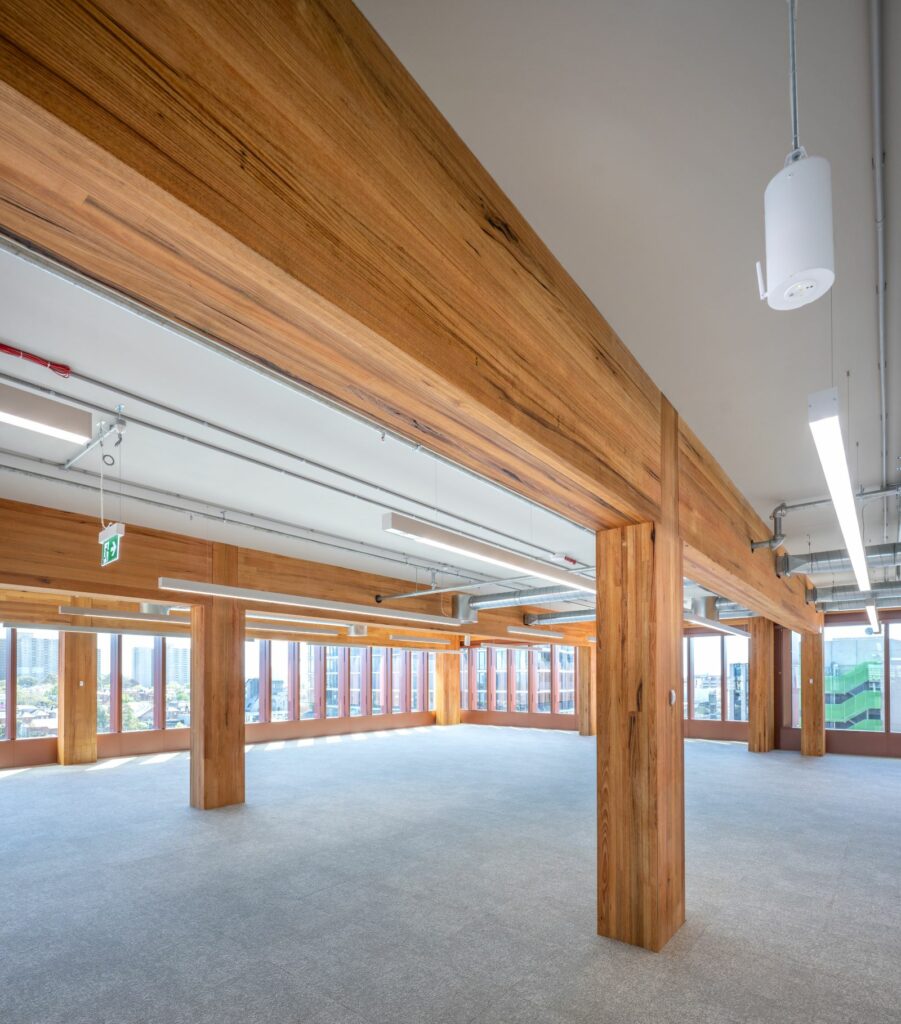 T3 Collingwood featuring MASSLAM columns and beams. Image: ICON Internal view of the completed T3 Collingwood mass timber commercial office tower by Hine, featuring ASH's MASSLAM. Image courtesy: ICON