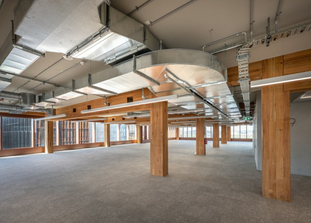 Internal view of T3 Collingwood mass timber office building. Image: ICON Internal view of the completed T3 Collingwood mass timber commercial office tower by Hine, featuring ASH's MASSLAM. Image courtesy: ICON