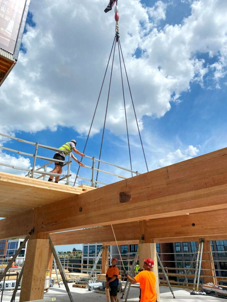 T3 Collingwood during construction. Image credit: ASH T3 Collingwood during construction lifting ASH's MASSLAM (mass timber) beams into place. Image credit: ASH