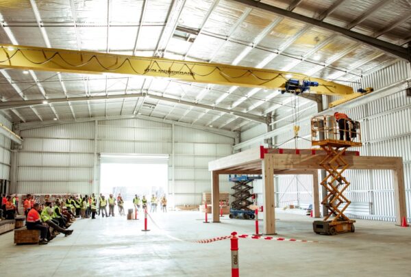 MASSLAM-Open-Day (90)_web Attendees at ASH's MASSLAM Open Day witnessing a live, full-scale installation demonstration of our Advanced Timber Composite (ATC) flooring at our Heyfield mass timber production facility.