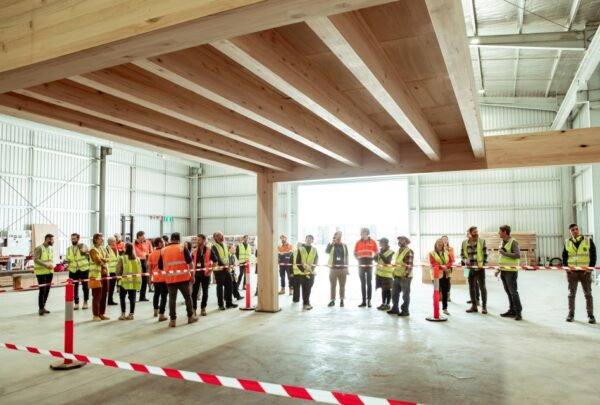 MASSLAM-Open-Day (94)_web Attendees at ASH's MASSLAM Open Day getting a close up look at our Advanced Timber Composite Flooring (ATC) solution after witnessing a live, full-scale installation demo at our Heyfield mass timber production facility.
